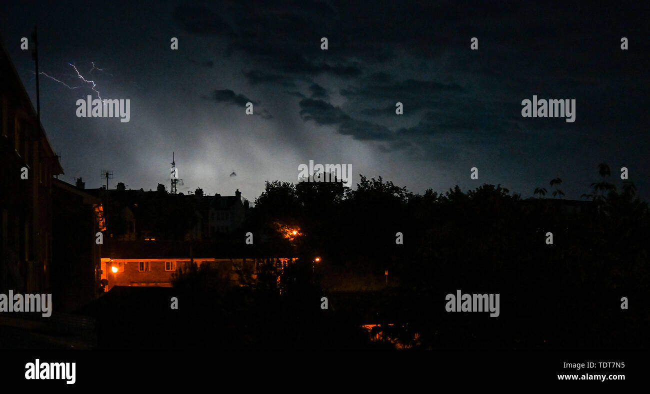 Brighton UK 18th June 2019 - A thunder and lightning storm lights up the skies above the Queens Park area of Brighton this evening as they move across the south east of Britain bringing a threat of more flooding to some parts of the UK . Credit : Simon Dack / Alamy Live News Stock Photo
