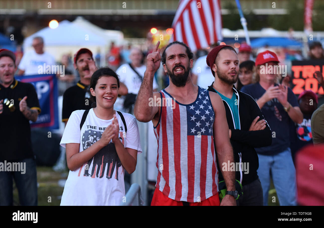 Orlando, Florida, USA. 18th June, 2019. Supporters of U.S. President Donald Trump react as they view Trump's remarks at a Make America Great Again rally on a video screen outside the Amway Center on June 18, 2019 in Orlando, Florida. This is the kick-off event for Trump's campaign for re-election in 2020. Credit: Paul Hennessy/Alamy Live News Stock Photo