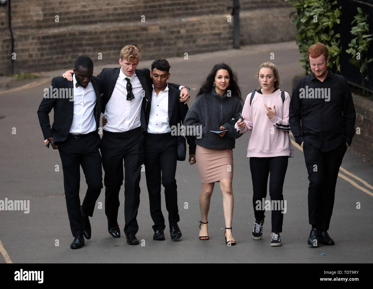 Cambridge, Cambridgeshire, UK. 18th June, 2019. University students make their way home in the early hours of the morning after celebrating the end of their exams and attending the Trinity May Ball, Cambridge, Cambridgeshire, on June 18, 2019. Credit: Paul Marriott/Alamy Live News Stock Photo
