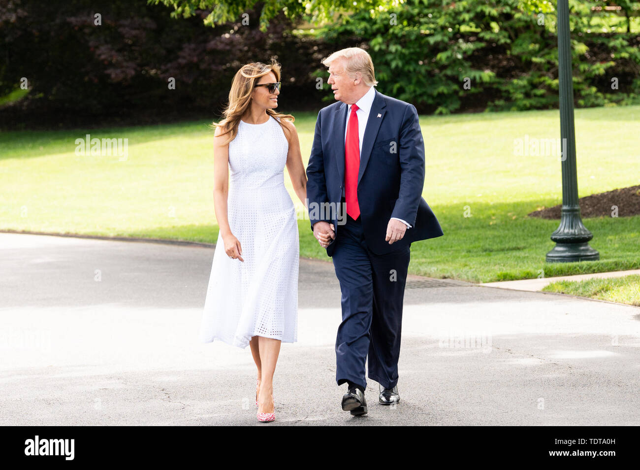 President Donald Trump walking with First Lady Melania Trump near the White  House South Lawn just prior to getting on Marine One, to start a trip to  Florida where he is to