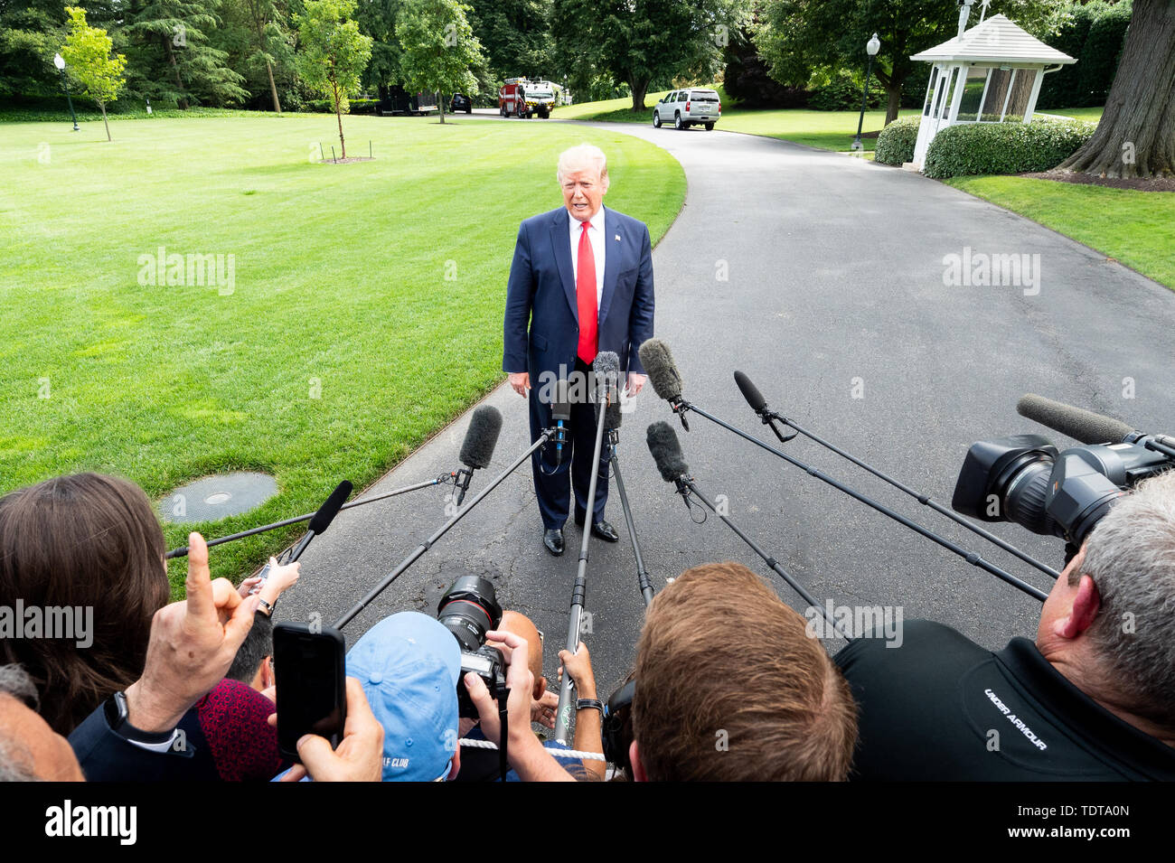 President Donald Trump talking with the press near the White House South Lawn just prior to getting on Marine One, to start his trip to Florida where he is to appear at a rally there, at the White House in Washington, DC. Stock Photo