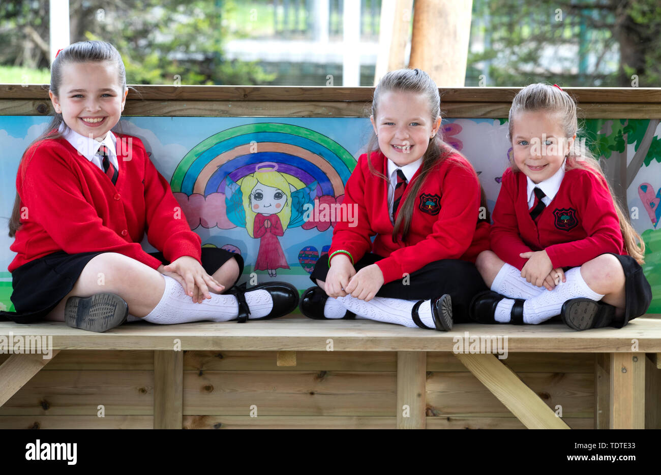 Embargoed to 0001 Thursday June 20 Pupils (left to right) sisters Kacie, 9, and Isla, 7, and Jorgia Cowie, 5, from Chapelside Primary School, Airdrie, sit alongside some of their artwork inside the new play shelter dedicated to former pupil Alesha MacPhail. Stock Photo