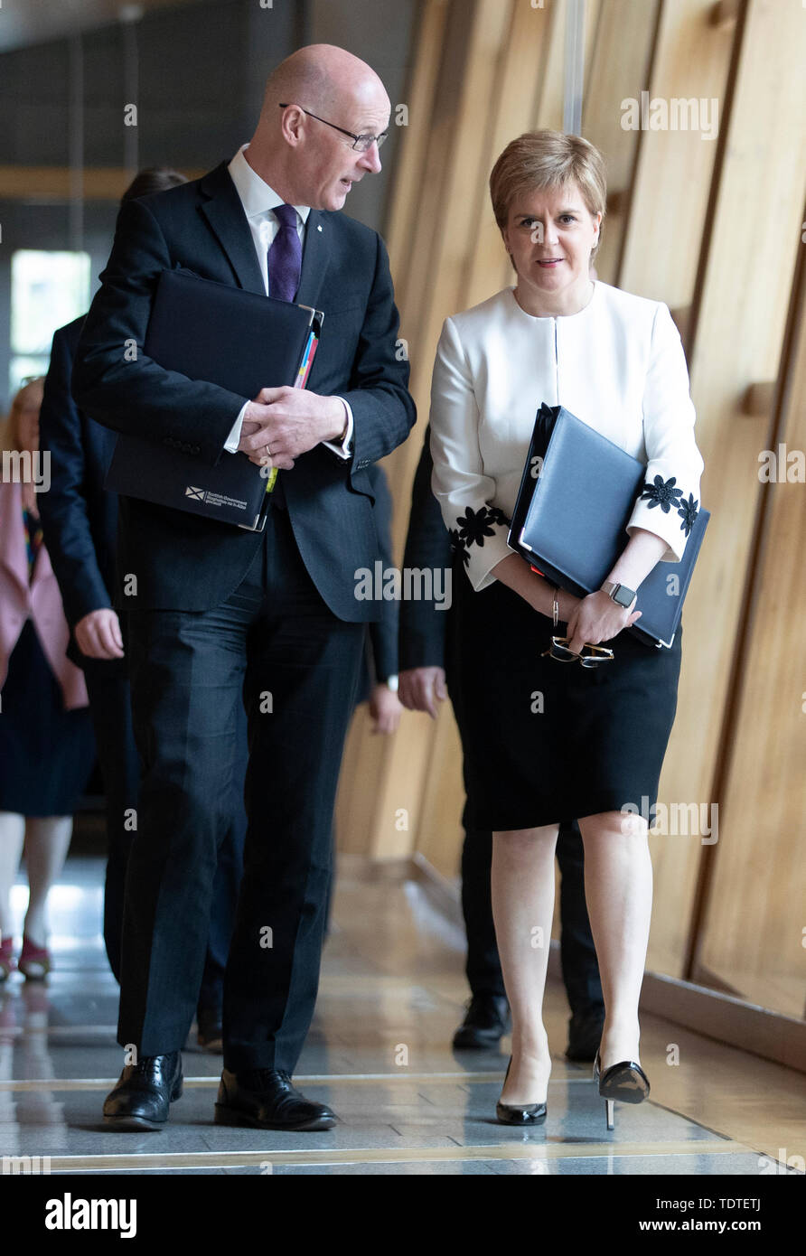 First Minister Nicola Sturgeon and Deputy First Minister John Swinney (left) arrive ahead of First Minister's Questions at the Scottish Parliament in Edinburgh. Stock Photo