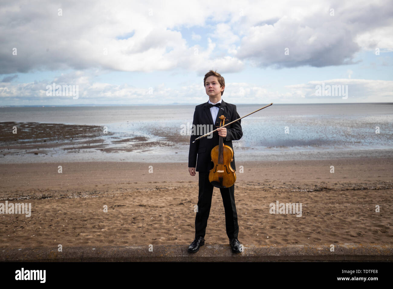 Viktor Seifert, 12, from St Mary's Music School in Edinburgh, plays the Orca Driftwood Viola by the sea at Musselburgh, East Lothian, ahead of his performance at the Royal Academy of Music in London on July 18th 2019, in the 'Dance For The Sea' event which supports the work of the Marine Conservation Society. Stock Photo