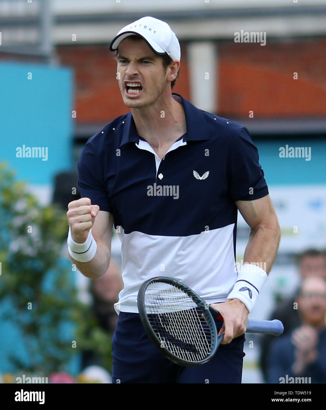 Andy Murray celebrates a point during his doubles match on day four of