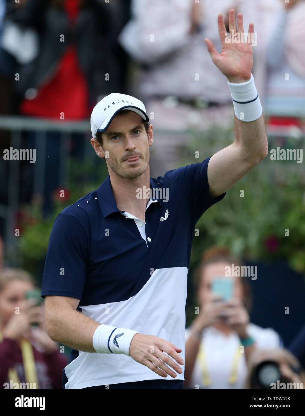 Andy Murray celebrates victory during his doubles match on day four of