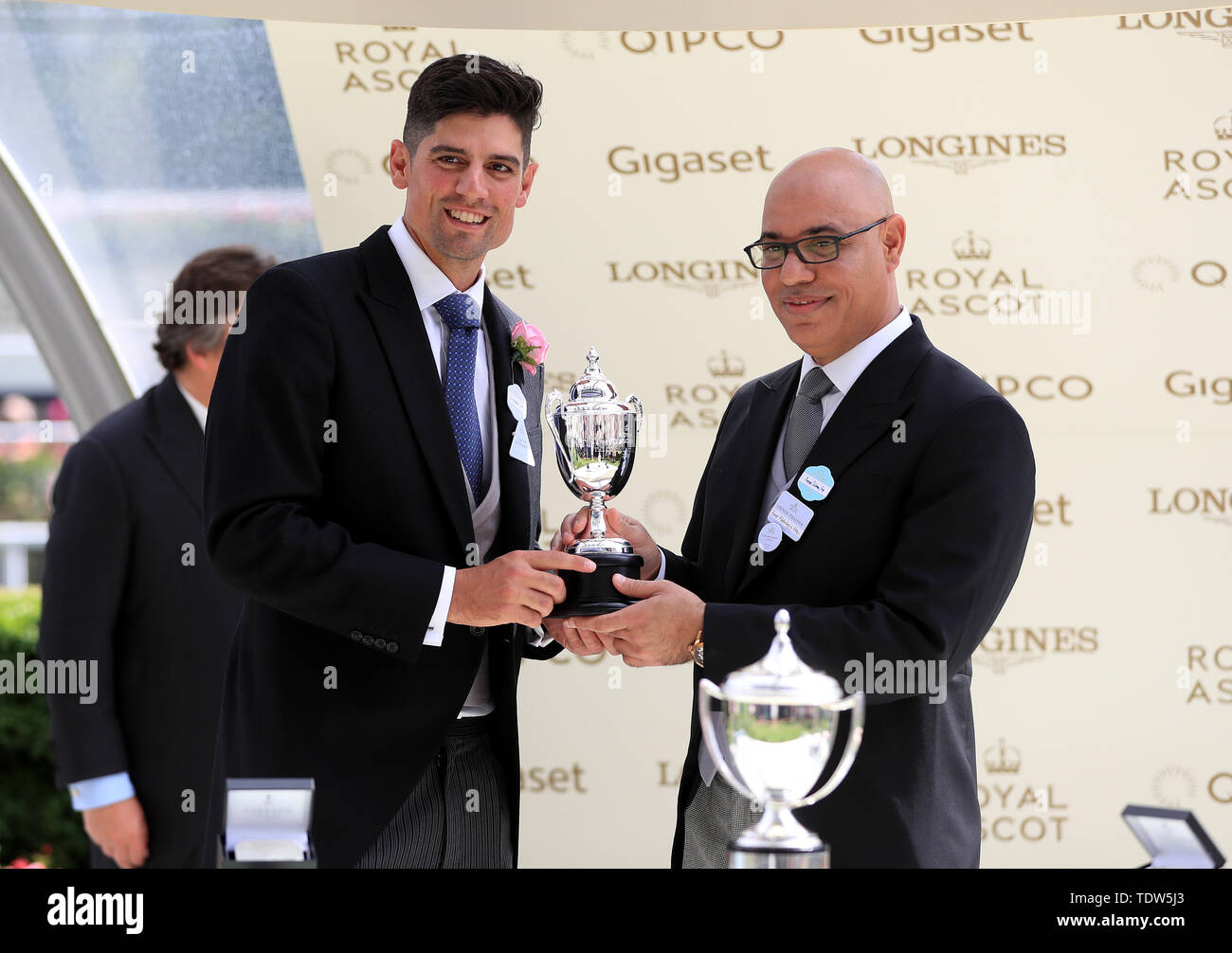 Sir Alastair Cook (left) presents Amer Abdulaziz of Phoenix Thoroughbreds a trophy after Advertise wins the Commonwealth Cup during day four of Royal Ascot at Ascot Racecourse. Stock Photo