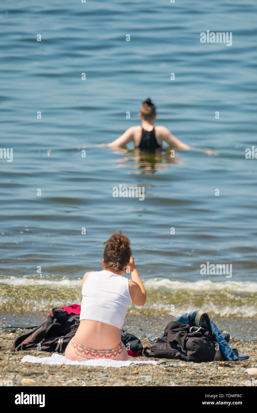 Aberystwyth Wales UK, Wednesday 19 June 2019 UK Weather:After days of unseasonal heavy rain and grey overcast skies, the sun makes a welcome appearance, and draws people back to the beach and the promenade in Aberystwyth on the Cardigan Bay coast, west Wales photo Credit: keith morris/Alamy Live News Credit: keith morris/Alamy Live News Stock Photo