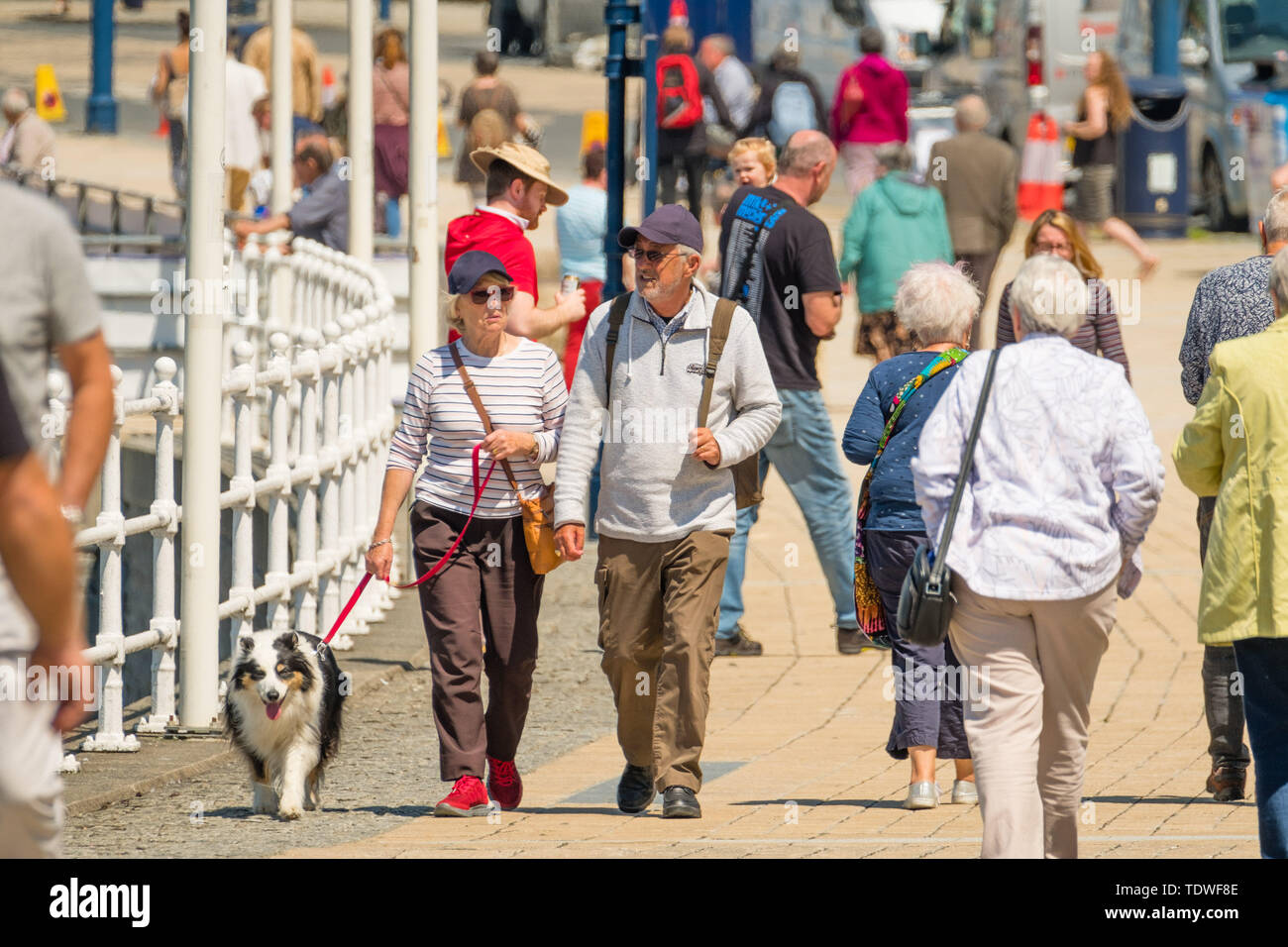 Aberystwyth Wales UK, Wednesday 19 June 2019 UK Weather:After days of unseasonal heavy rain and grey overcast skies, the sun makes a welcome appearance, and draws people back to the beach and the promenade in Aberystwyth on the Cardigan Bay coast, west Wales photo Credit: keith morris/Alamy Live News Credit: keith morris/Alamy Live News Stock Photo