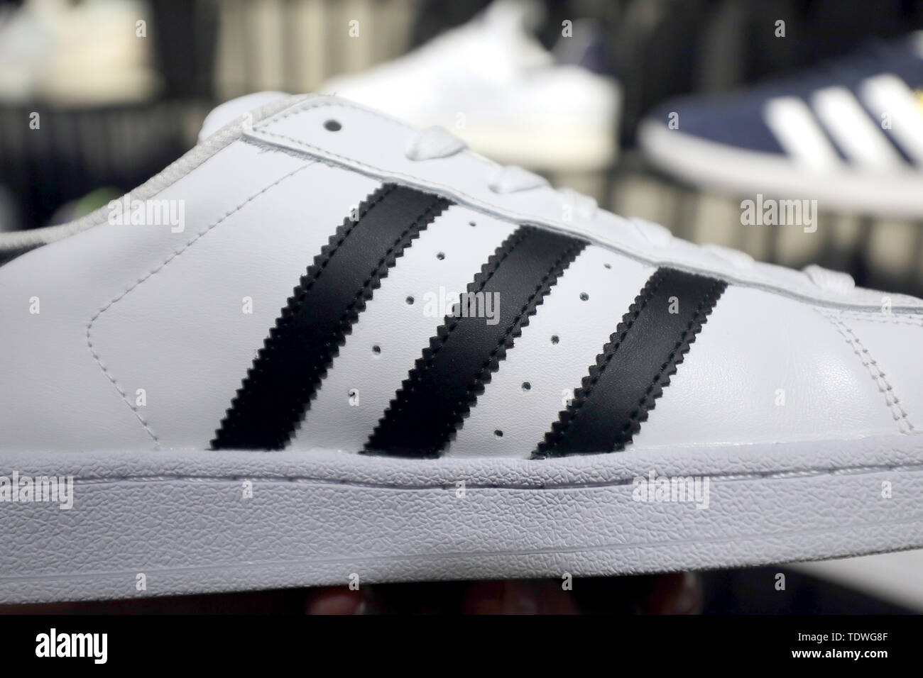 calendar storage Tether Berlin, Germany. 19th June, 2019. A sports shoe with the famous three  stripes can be bought in a shop on the shelf. The sporting goods  manufacturer Adidas has lost the right to