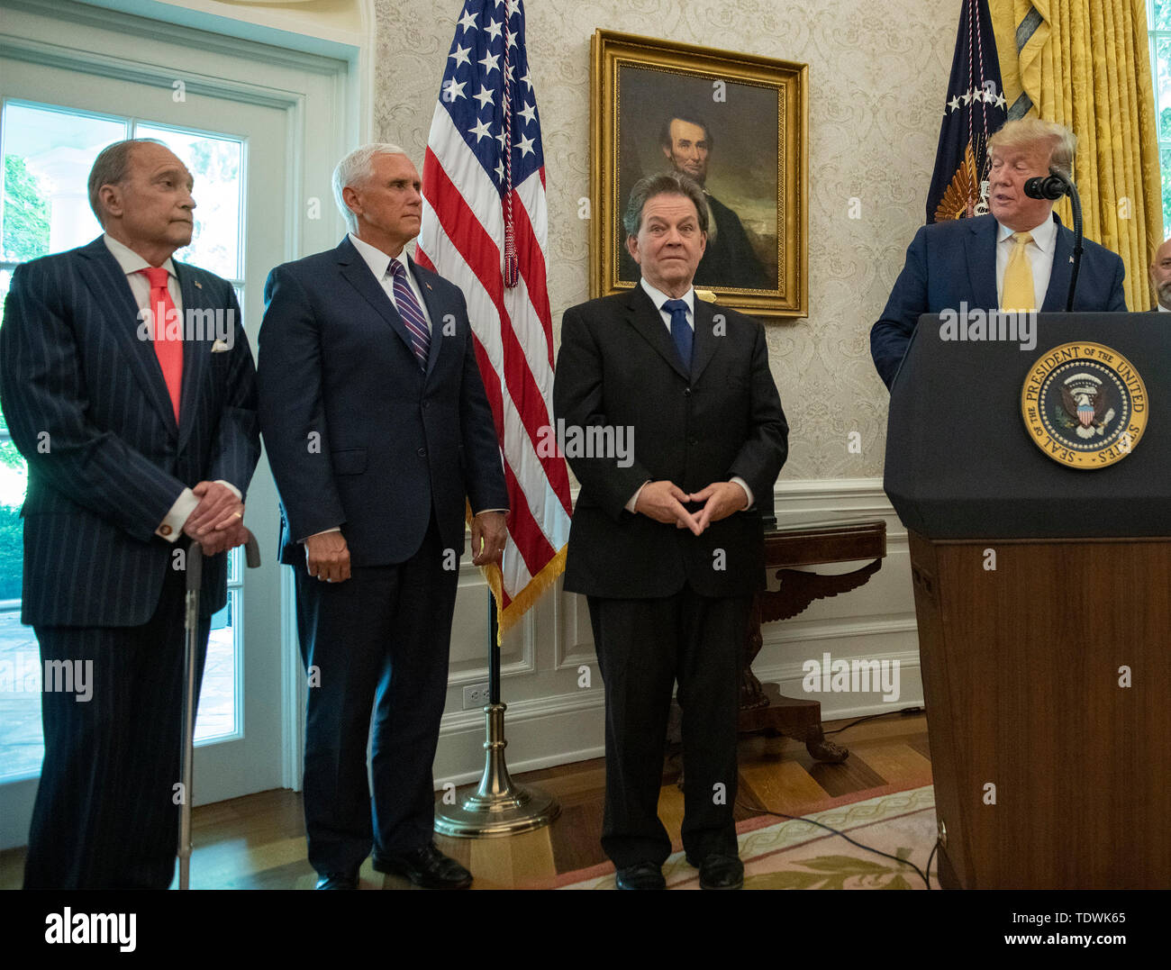 United States President Donald J. Trump, right, makes remarks prior to presenting the Presidential Medal of Freedom to Arthur Laffer, left, in the Oval Office of the White House in Washington, DC on Wednesday, June 19, 2019. Laffer the originated the 'Laffer Curve' that seemingly shows the more taxes are cut, the more economic activity there is, and that increase offsets the effects of the tax cut. Pictured from left to right: Director of the National Economic Council Larry Kudlow, US Vice President Mike Pence, Laffer, and President Trump. Credit: Ron Sachs/Pool via CNP | usage worldwide Stock Photo