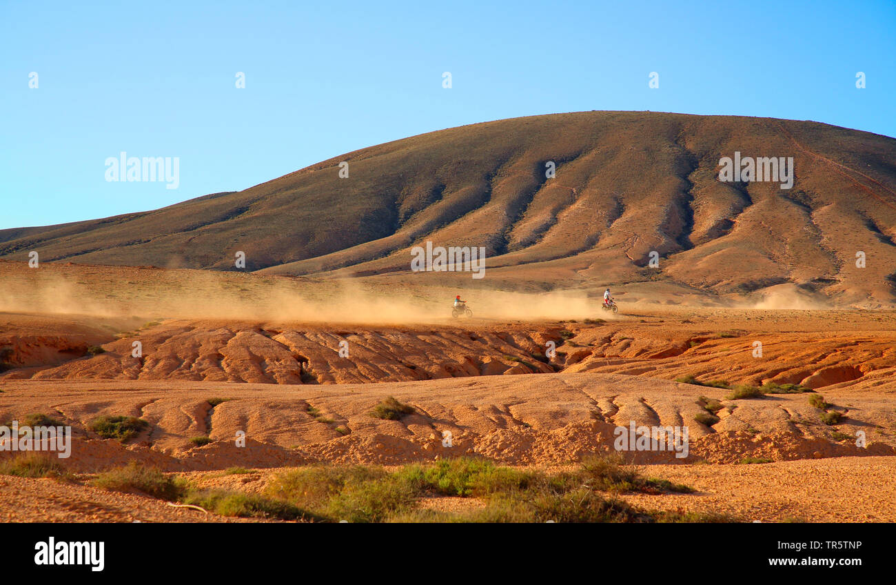 motocross driver speed in semidesert, Canary Islands, Fuerteventura, La Olivia Stock Photo