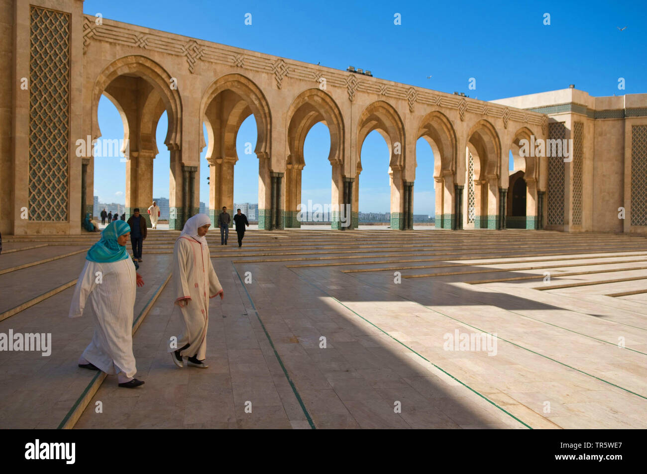 Hassan II mosque, women walking to theire site, Morocco, Casablanca Stock Photo