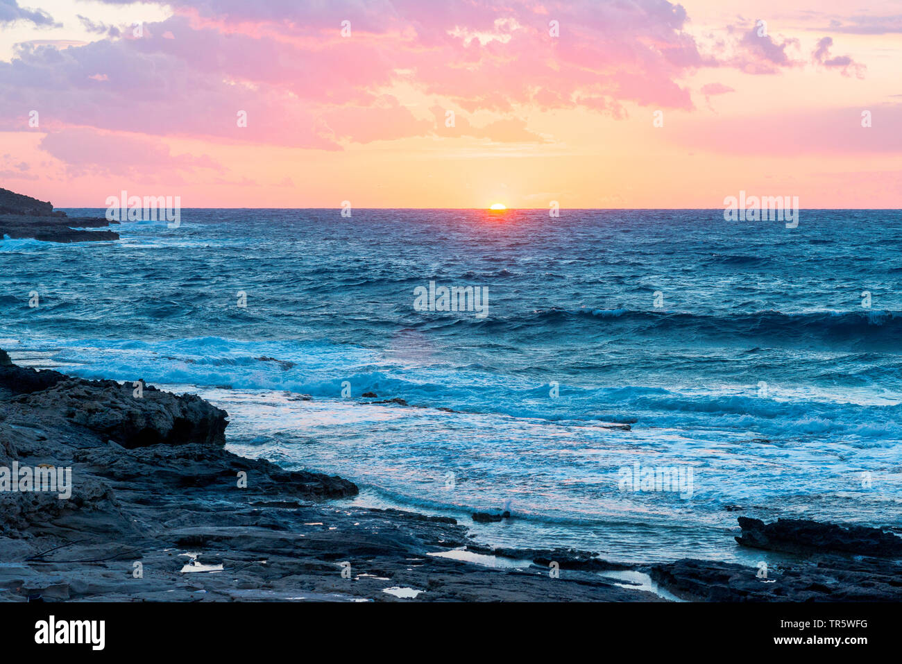 breaking waves at the coast of North Cyprus at sunset, Cyprus Stock Photo