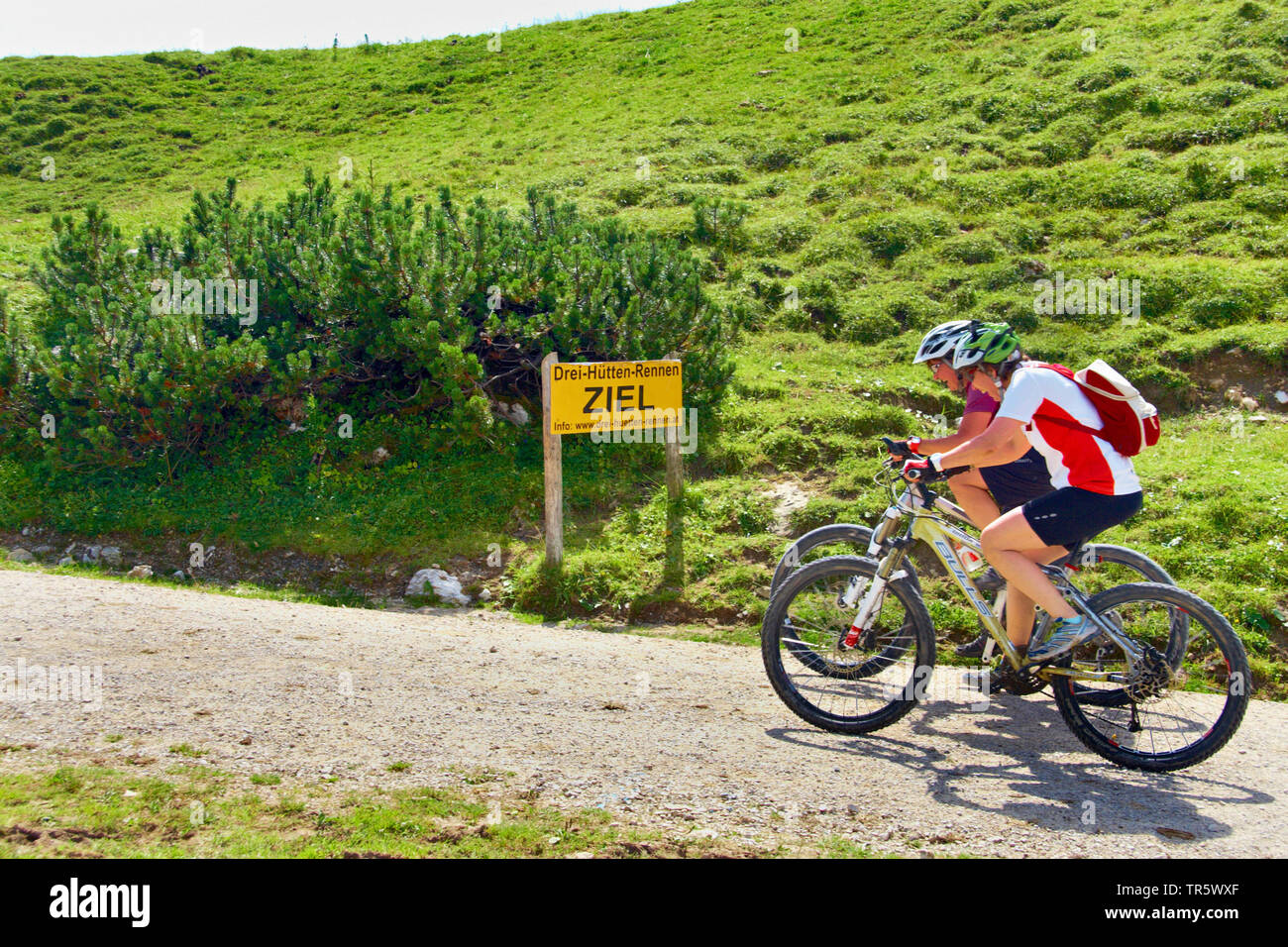 two mountainbiker at the finish, Austria, Tyrol, Tannheim Valley Stock Photo