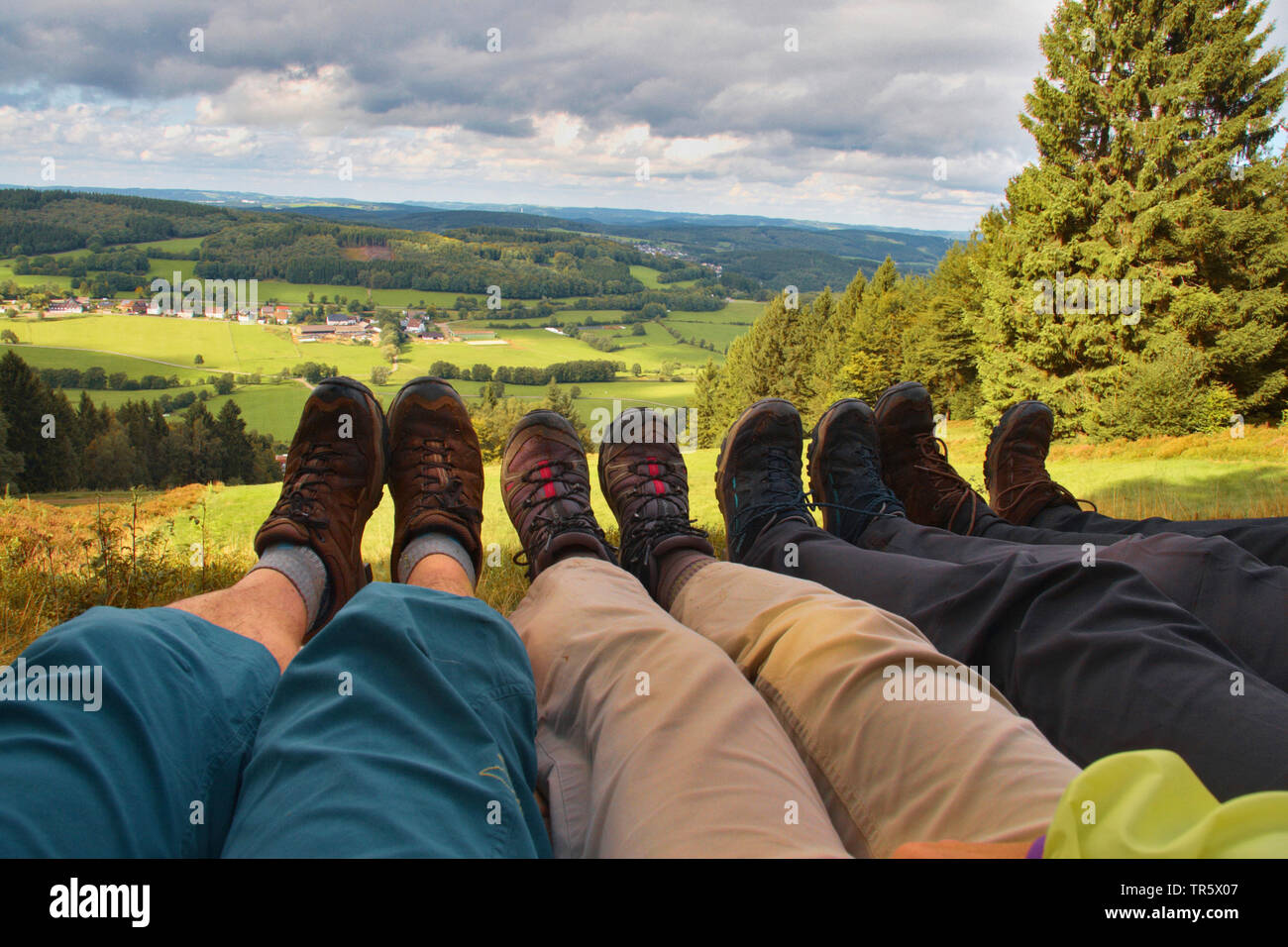 wanderers having a break and putting their feet up, Germany, North Rhine-Westphalia, Sauerland, Nordhelle Stock Photo