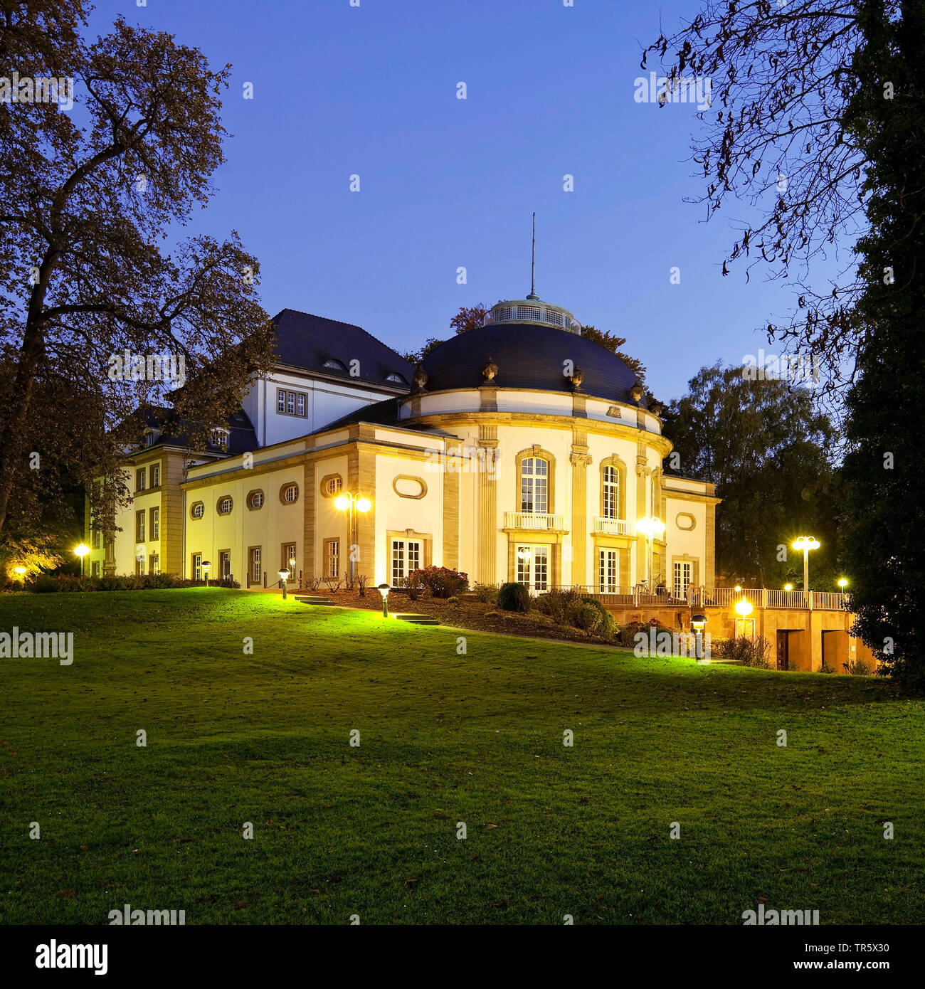 illuminated theatre in the spa park at blue hour, Germany, North Rhine-Westphalia, East Westphalia, Bad Oeynhausen Stock Photo