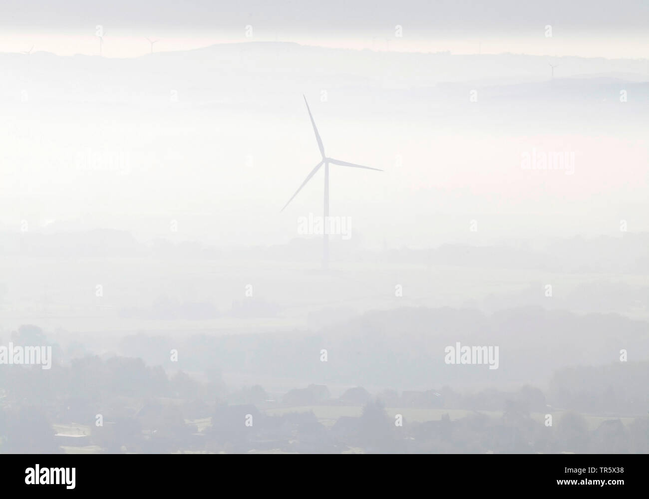 misty landscape with wind wheel at Porta Westfalica, Germany, North Rhine-Westphalia, East Westphalia, Porta Westfalica Stock Photo