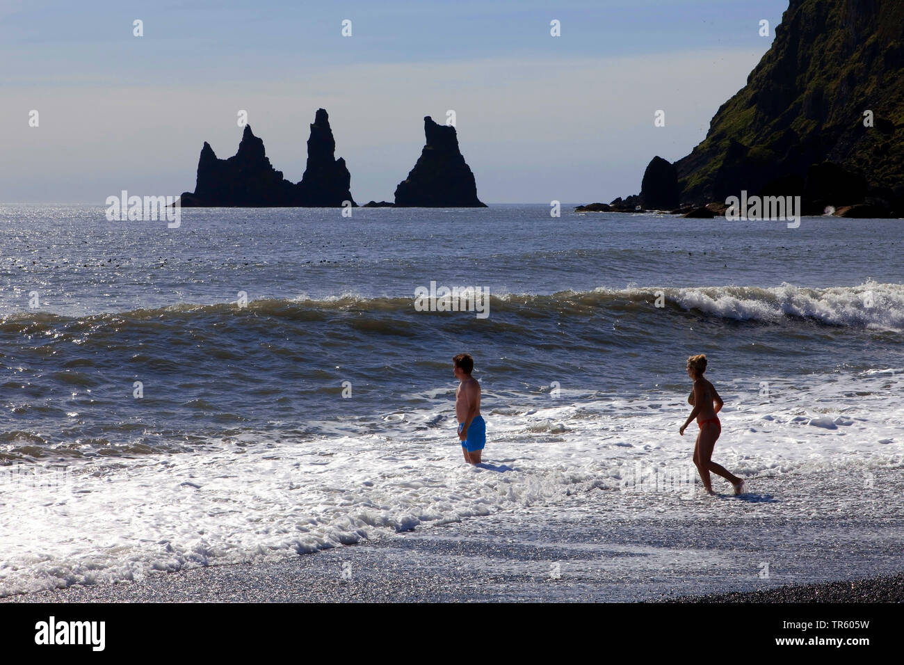 persons on the beach at rock needles at Reynisdrangar at Vik i¡ Myrdal, Iceland, South Iceland, Reynisdrangar Stock Photo