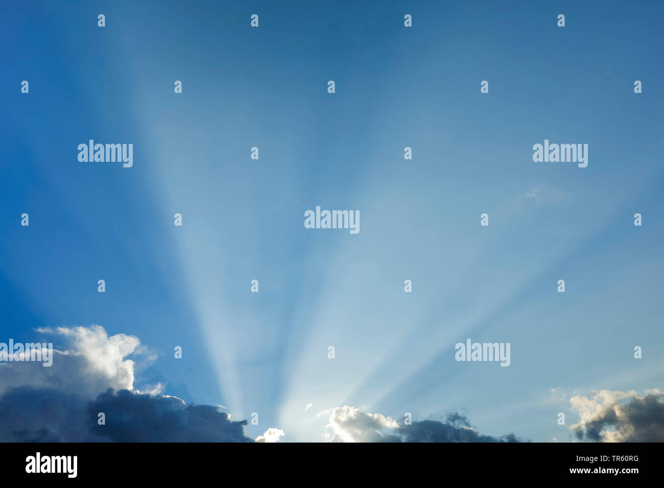 sunbeams and clouds at blue sky, Switzerland Stock Photo