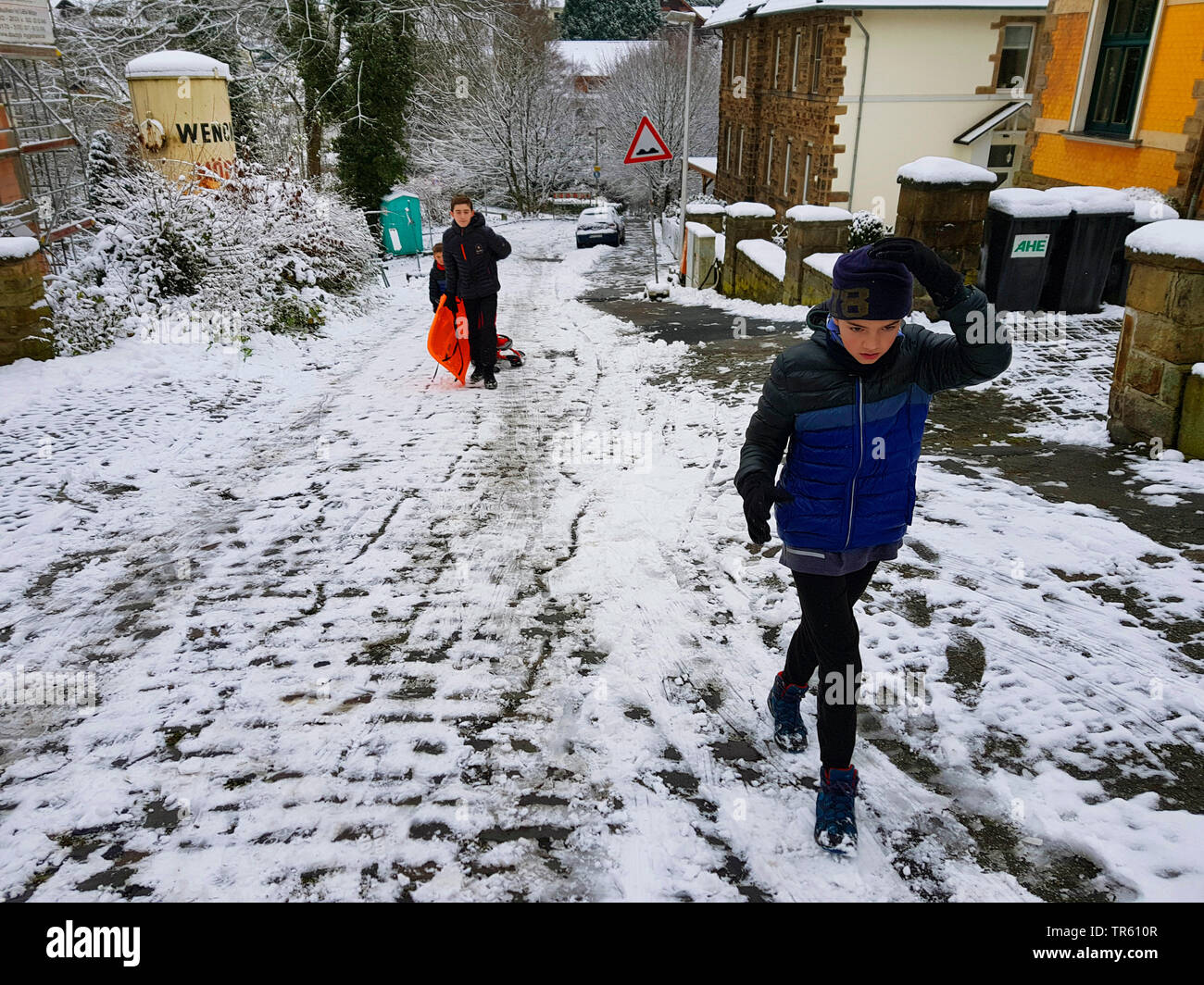children with ski bob on a street, Germany, North Rhine-Westphalia, Ruhr Area, Witten Stock Photo
