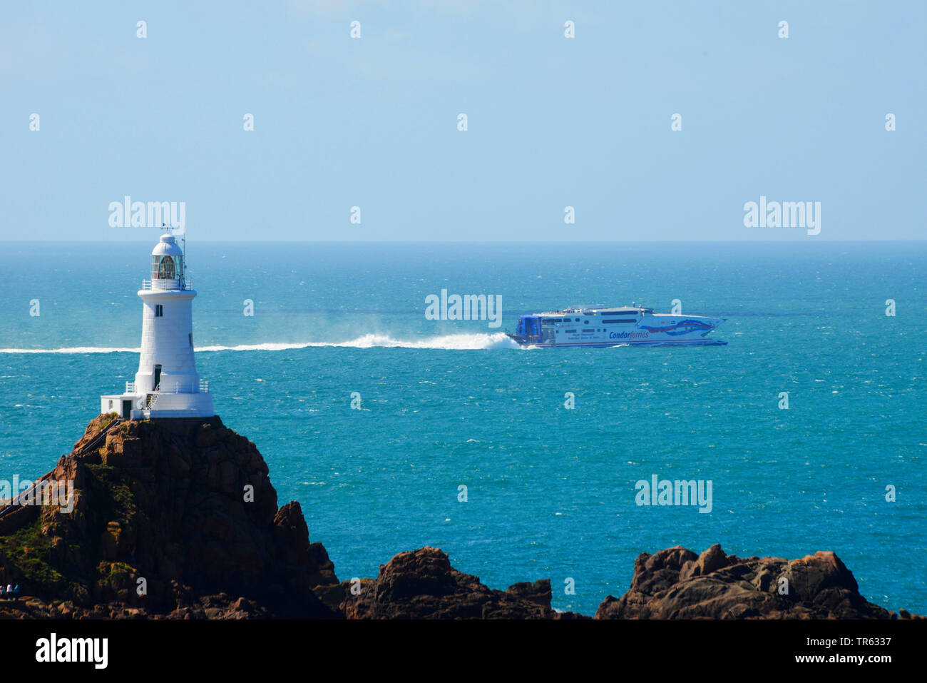 Corbiere Lighthouse, ferry in the background, United Kingdom, Jersey Stock Photo