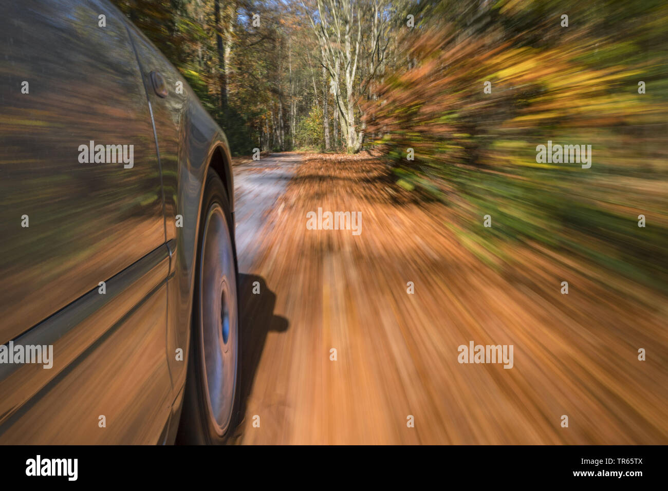 Car driving on a street in autumn, Germany, Bavaria Stock Photo
