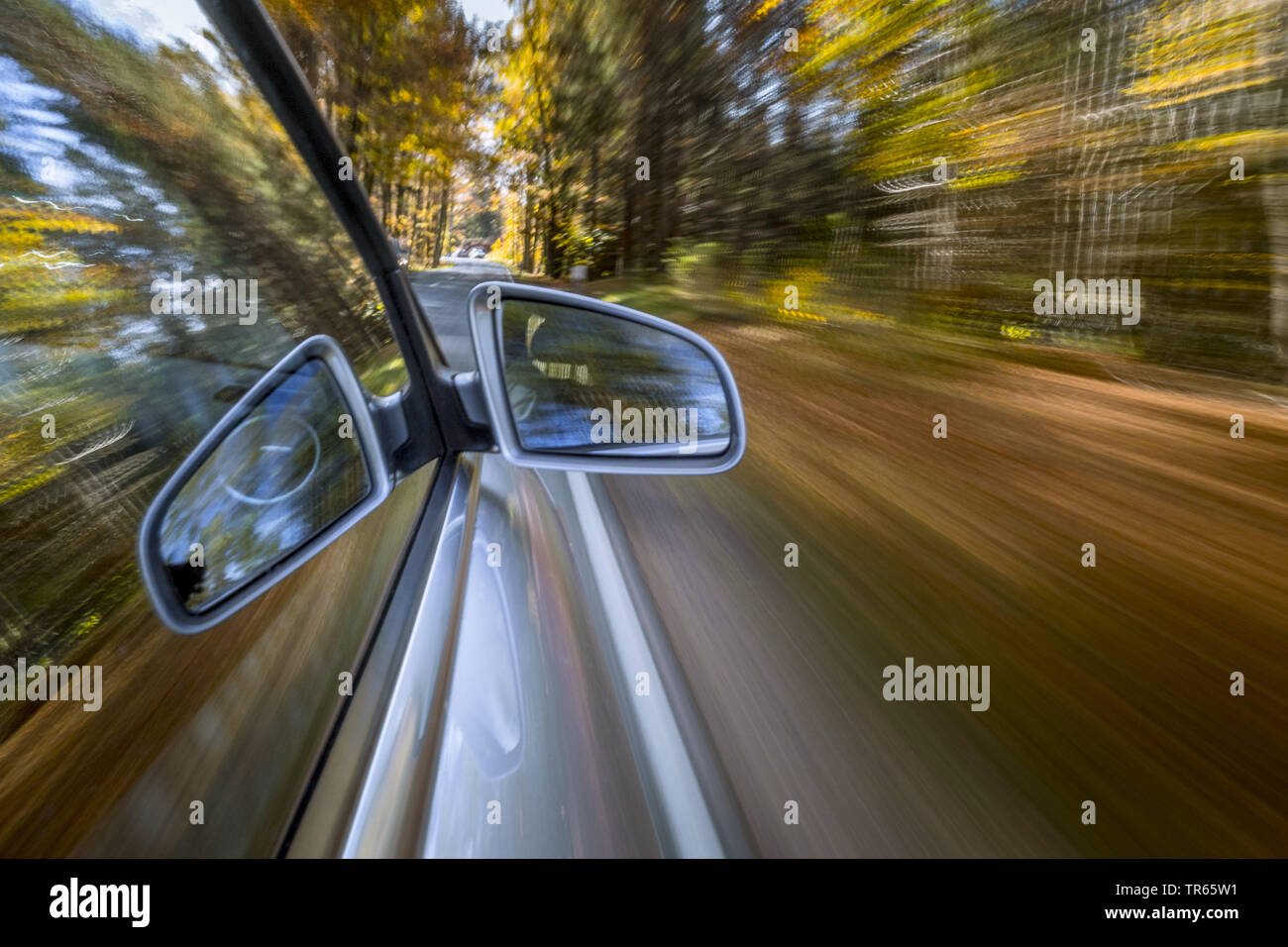 Car driving on a street in autumn, Germany, Bavaria Stock Photo