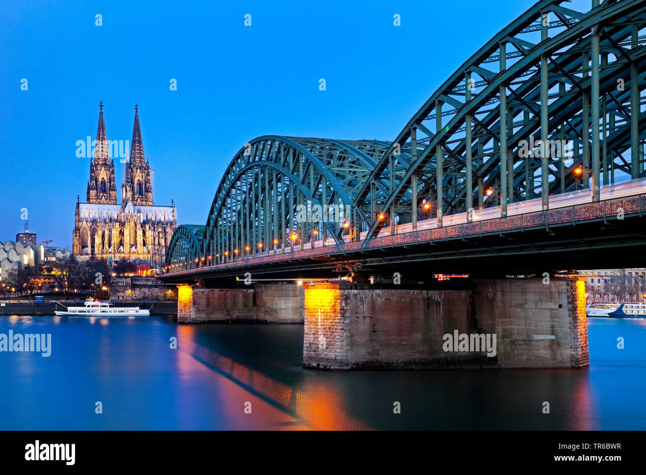 Cologne Cathedral and Hohenzollern Bridge in the evening, Germany, North Rhine-Westphalia, Lower Rhine, Cologne Stock Photo
