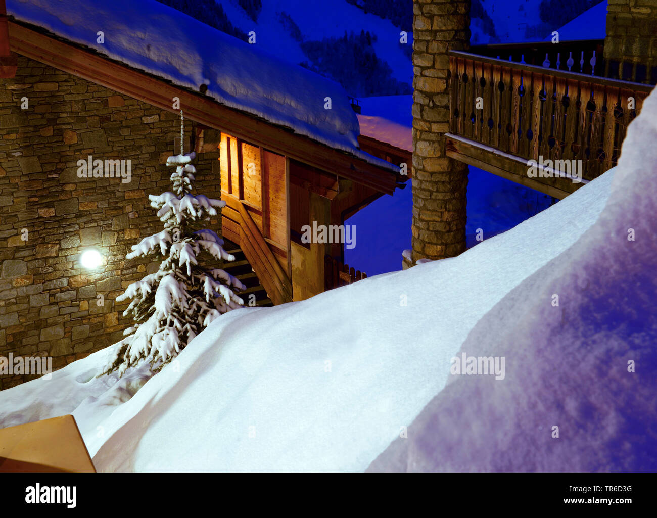snow-covered chalets at night, France, Savoie, Sainte Foy Tarentaise Stock Photo