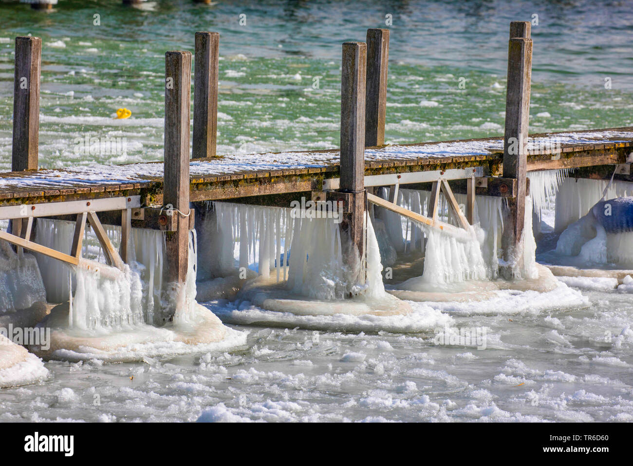 weirdly shaped icing on a bathing jetty after winter storm, Germany, Bavaria, Lake Chiemsee Stock Photo