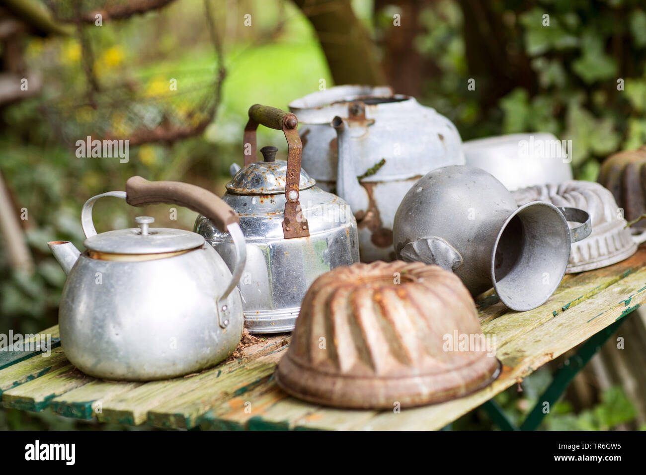 Old Kettles And Cake Pans As Garden Decoration Germany Stock