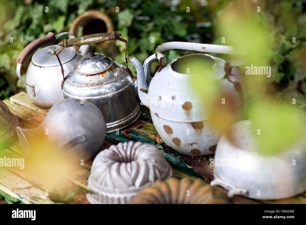 Old Kettles And Cake Pans As Garden Decoration Germany Stock