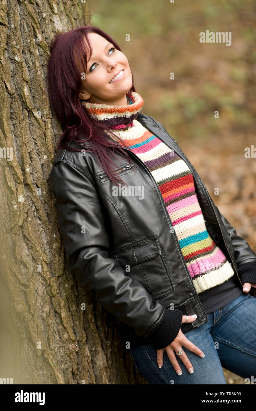 woman leans on a tree Stock Photo