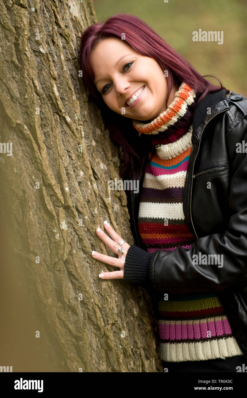 woman leans on a tree Stock Photo