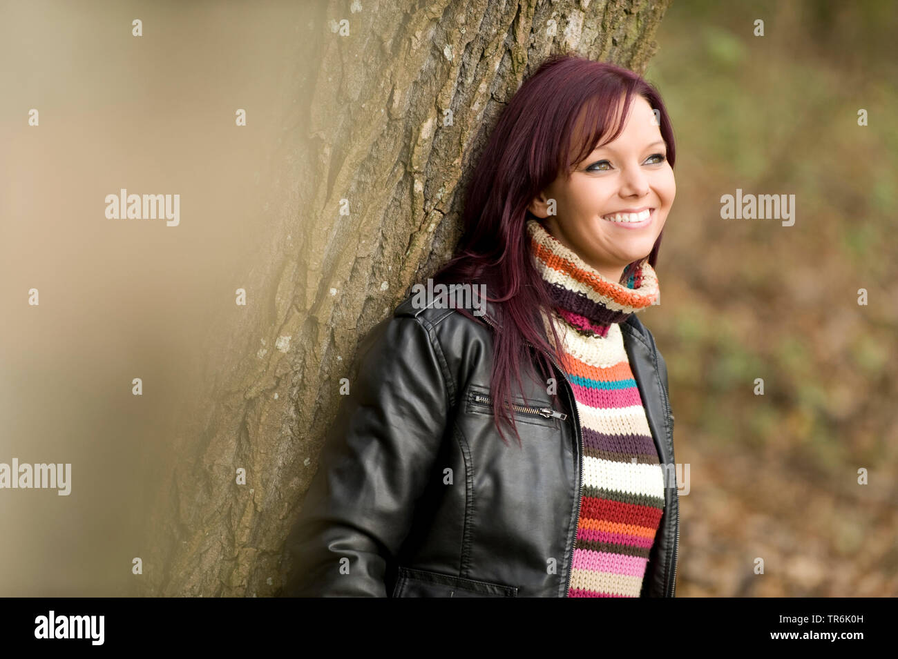 woman leans on a tree Stock Photo