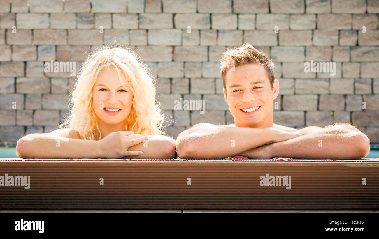 young couple relaxing at a pool, Germany Stock Photo