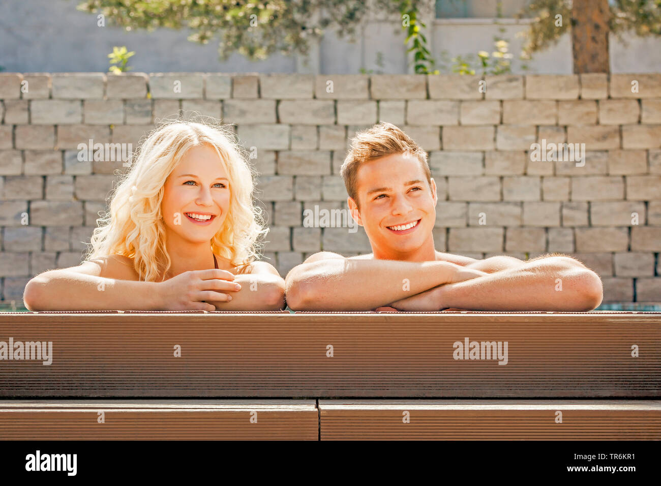 young couple relaxing at a pool, Germany Stock Photo