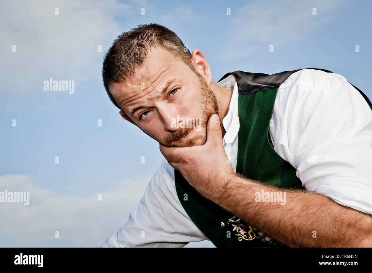 man in Bavarian traditional clothing doubting, Germany, Bavaria Stock Photo