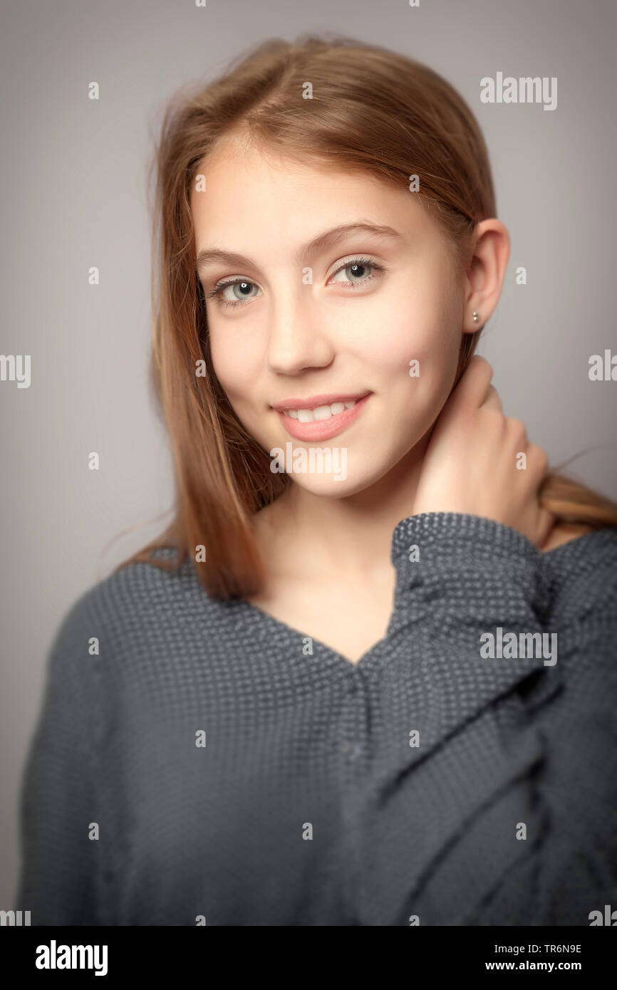 portrait of a young, very beauty girl with hand on neck, Germany Stock Photo