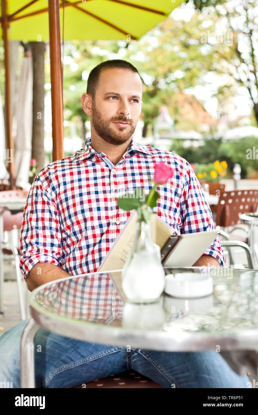 young man in an ice cafe, Germany Stock Photo
