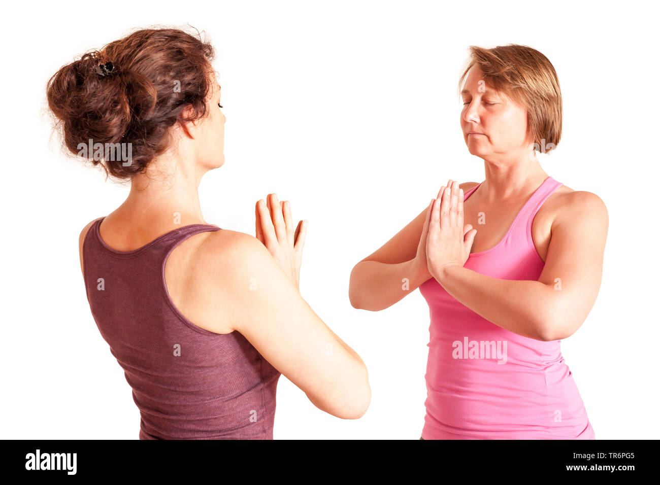 two women doing yoga in the living room at home Stock Photo