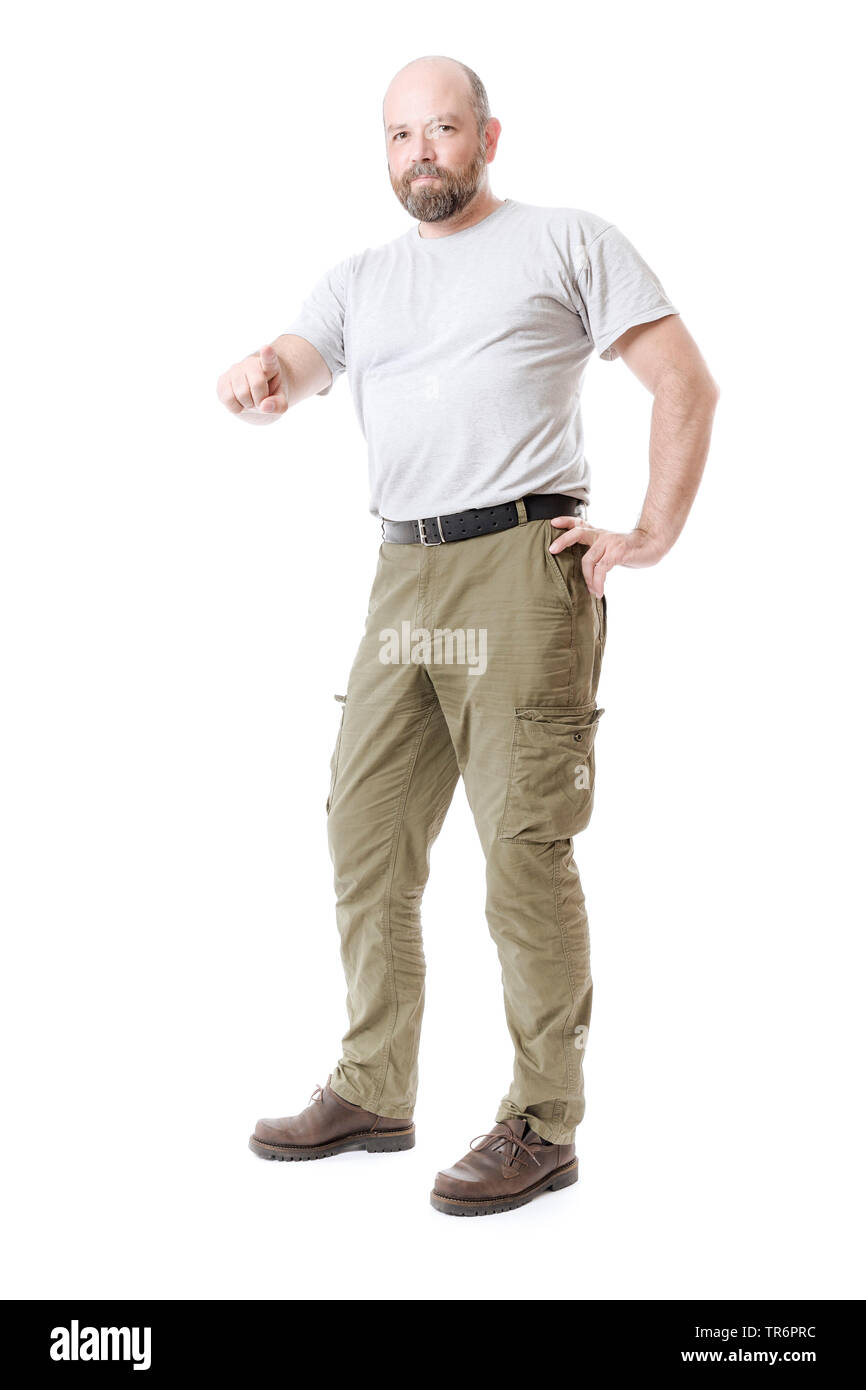 man with beard and frontal baldness pointing at something in front of white background, Germany Stock Photo