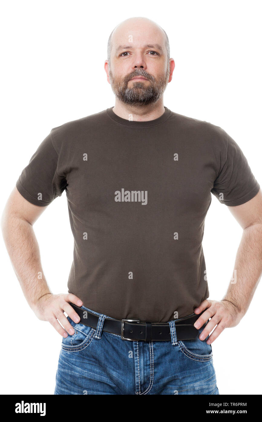 man with beard and bald head standing confidently with hands on hips, Germany Stock Photo