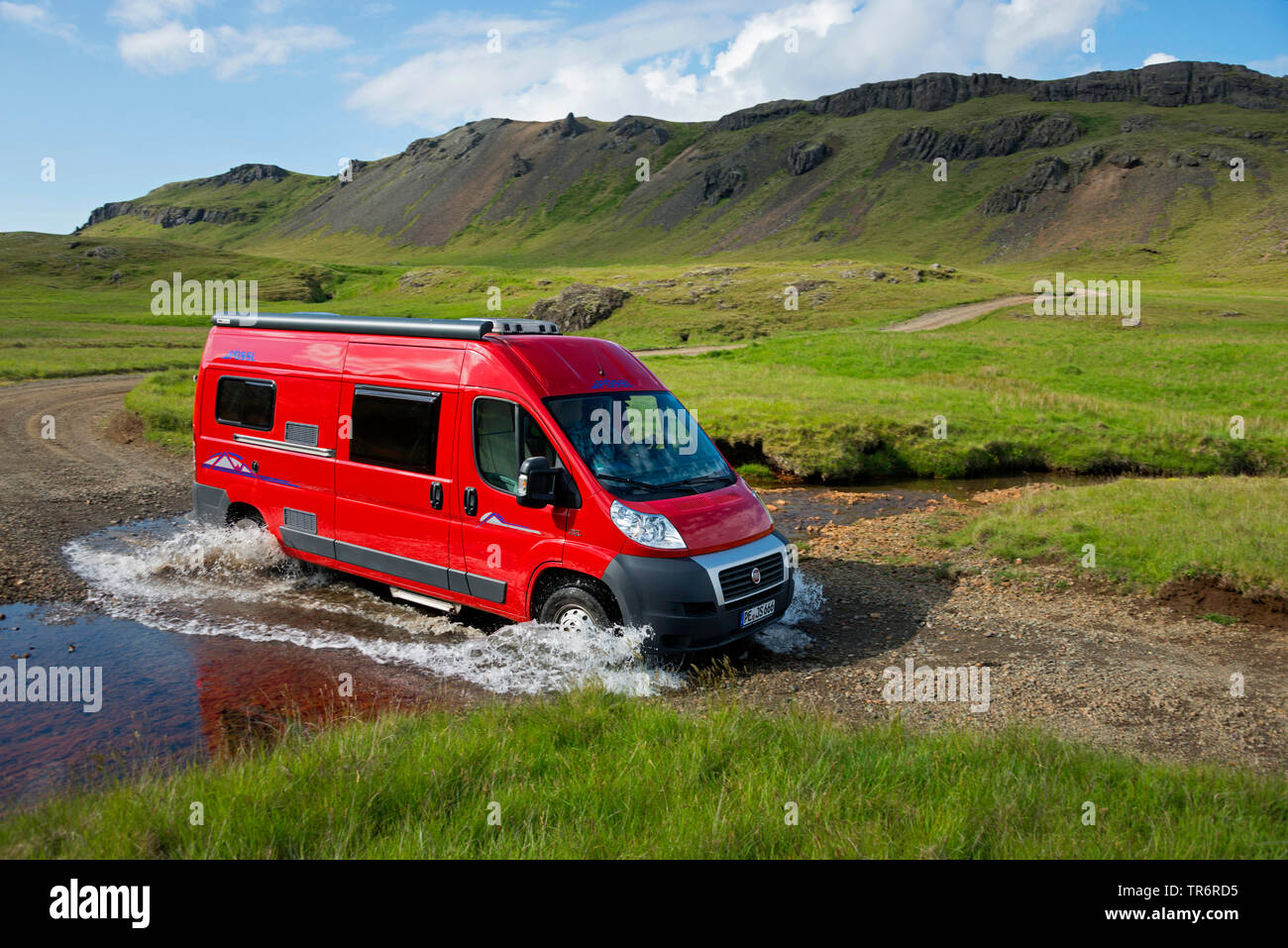 red recreational vehicles crossing river, Iceland, Kollumulavegur Stock Photo