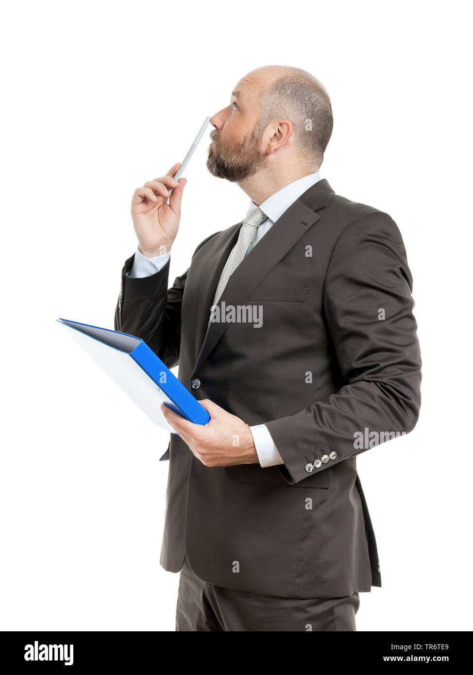 Middle-aged businessmann thinking about solutions and holding folder, Germany Stock Photo