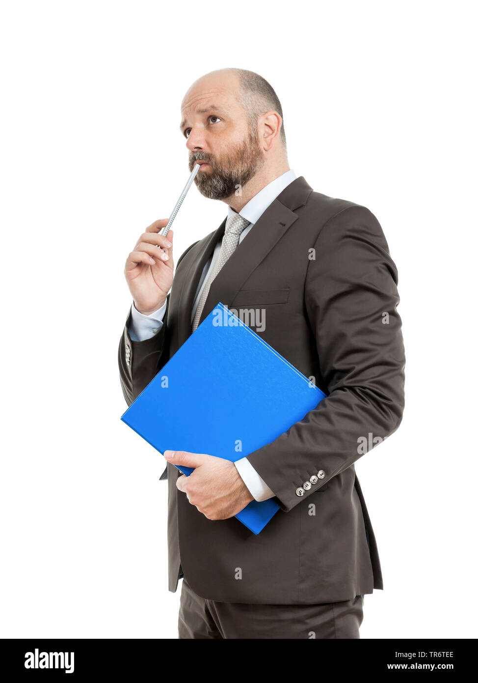 Middle-aged businessmann thinking about solutions and holding folder, Germany Stock Photo