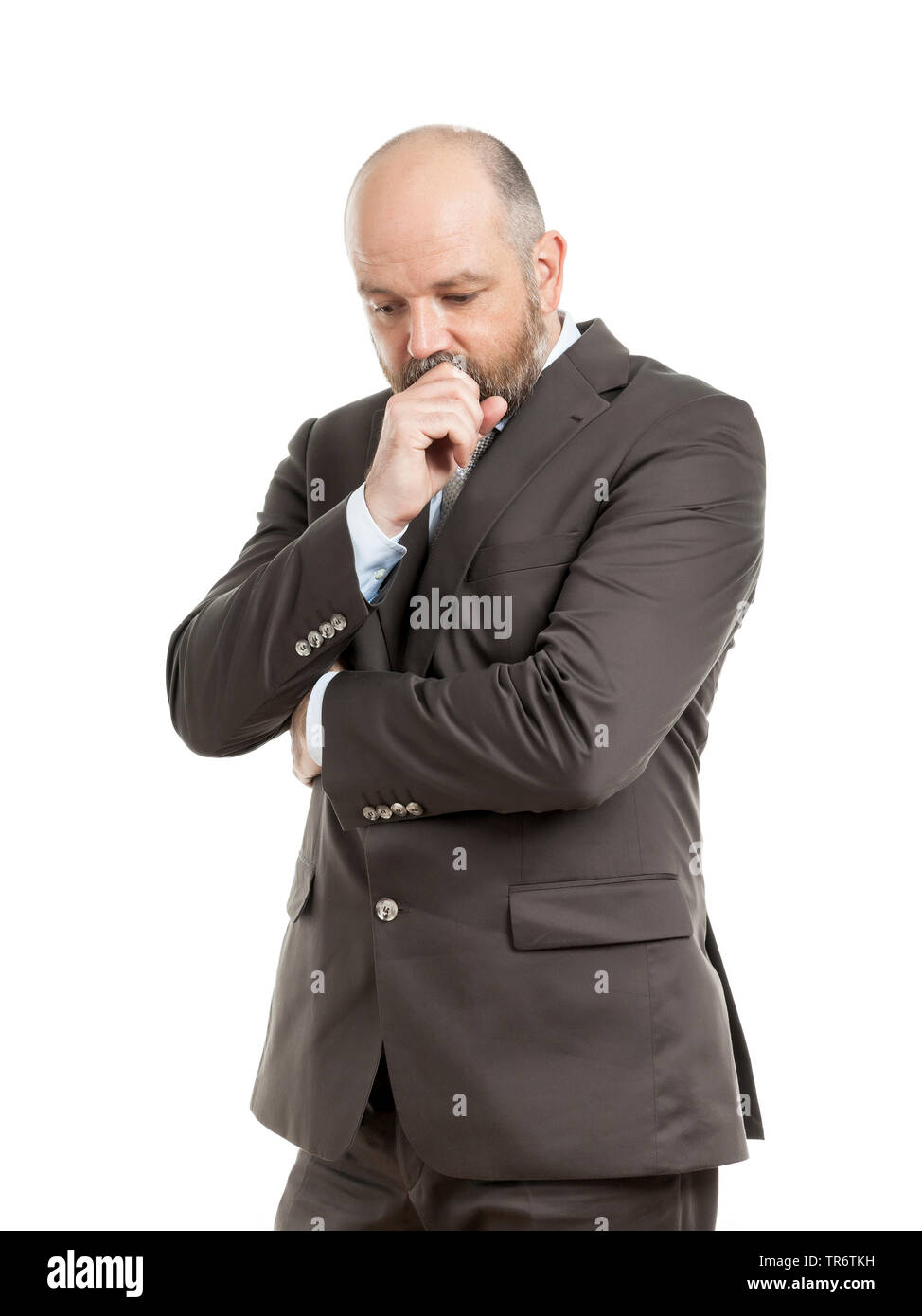Middle-aged businessmann reflecting with hand touching his face, Germany Stock Photo