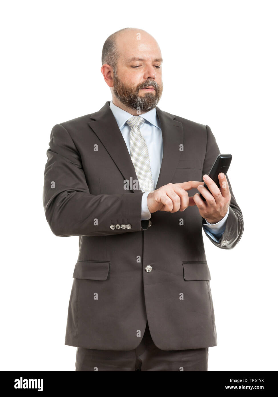 Middle-aged businessmann standing, using his mobile phone, Germany Stock Photo