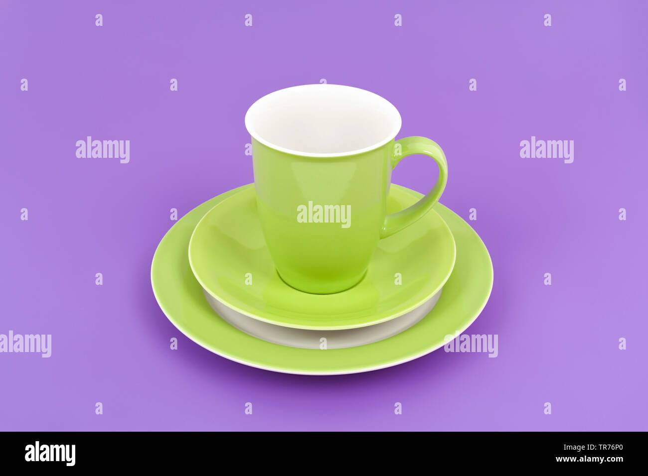 https://c8.alamy.com/comp/TR76P0/green-coffee-cup-on-purple-background-against-violet-background-TR76P0.jpg